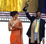 Priyanka’s-dad-holding-her-Miss-India-trophy